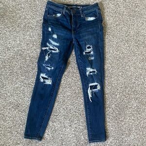 American Eagle covered rips blue jeans